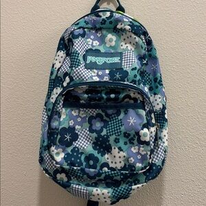 JanSport Half Pint mini backpack in blue and white floral and checkered pattern